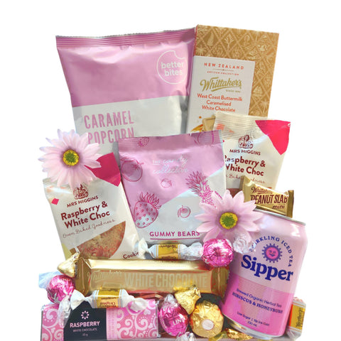 A beautifully designed box that radiates shades of pink, filled with handpicked delicious treats that will make the perfect gift!  Whittaker’s block  buttermilk white chocolate x1 Chocolate traders white chocolate raspberry bar x1 Mrs Higgins raspberry and white chocolate cookie x2 Better Bites caramel popcorn x1 Sipper sparkling ice tea hibiscus and honeybush can x1 Whittaker’s white chocolate bar x1 The Candy Collective gummy bears x1 Lindt strawberry truffles x3 Ferrero x1  Werther’s x6 Hershey’s kiss