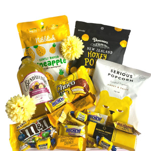 This bright and sunny gift box would be sure to bring a ray of sunshine to anyone’s day. Filled with a delicious range of treats, this box of sweet and fruity goodness is perfect for any occasion.  What's in the Box?  Serious popcorn x1 Bundaberg passionfruit bottle x1 Donovan’s hokey pokey clusters x1 Nibblish pineapple bites x1 Peanut M&Ms pouch x1 Chocolate traders manuka honey chocolate bar x1 Lotte banana choco pie x1 Whittaker’s hokey pokey crunch mini slab x4 Mini Toblerone x3 yellow candy x6