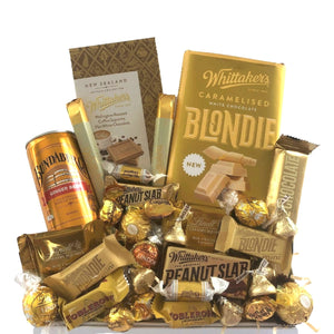perfect gift box for any occasion!Whittaker’s Blondie white caramelised chocolate block x1 Bundaberg ginger beer x1 Whittaker’s white chocolate sante bar x2 Lindt caramel squares x2 Whittaker’s white chocolate bar x1 Ferrero Rocher x2 Lindt truffle balls dulce de leche or white chocolate x4 Werther’s assorted x6 Hershey’s kisses x6 Whittaker’s flat white chocolate block x1 Whittaker’s peanut slab x1 Whittaker’s blondie and peanut slab mini x3